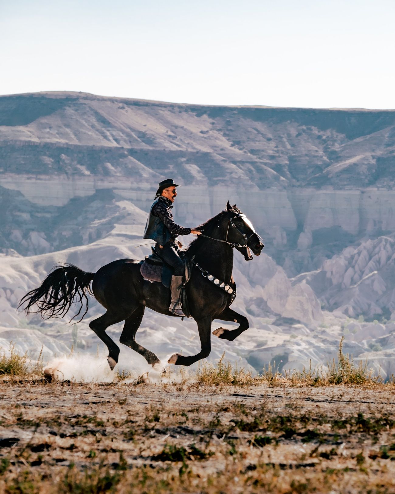 Videographer filming a rider in the Cappadocia valleys