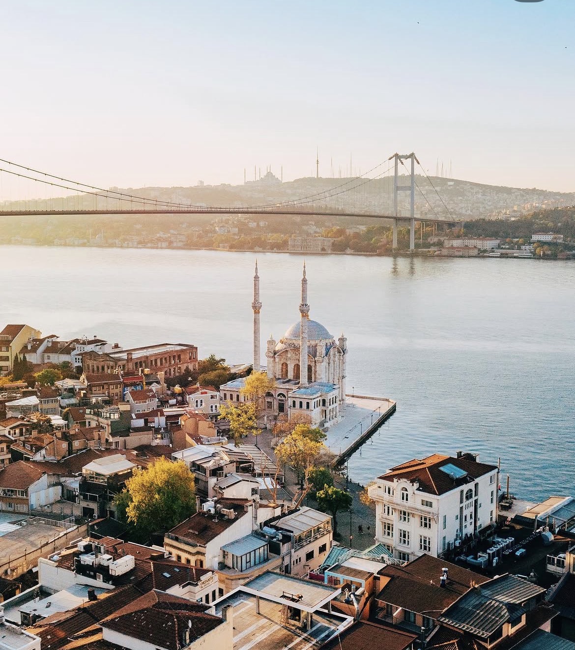 Aerial view of Ortaköy Mosque and the Bosphorus Bridge in Istanbul at sunrise